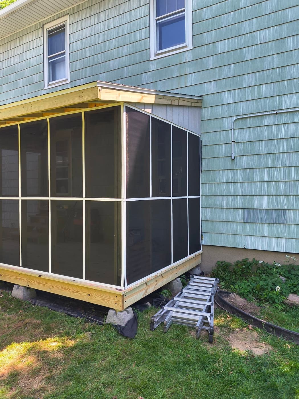 A finished screened porch enclosure on a new deck